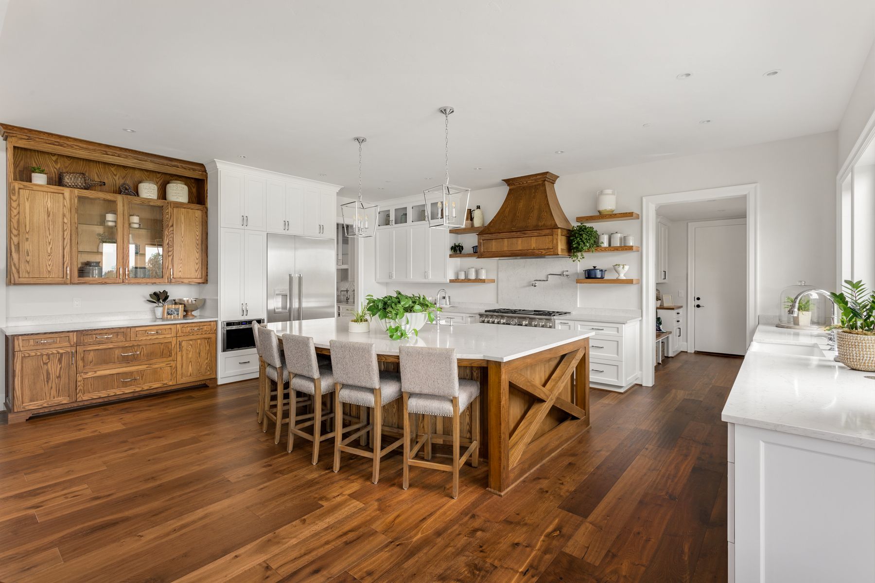 Wide-plank hardwood in a wood and white kitchen