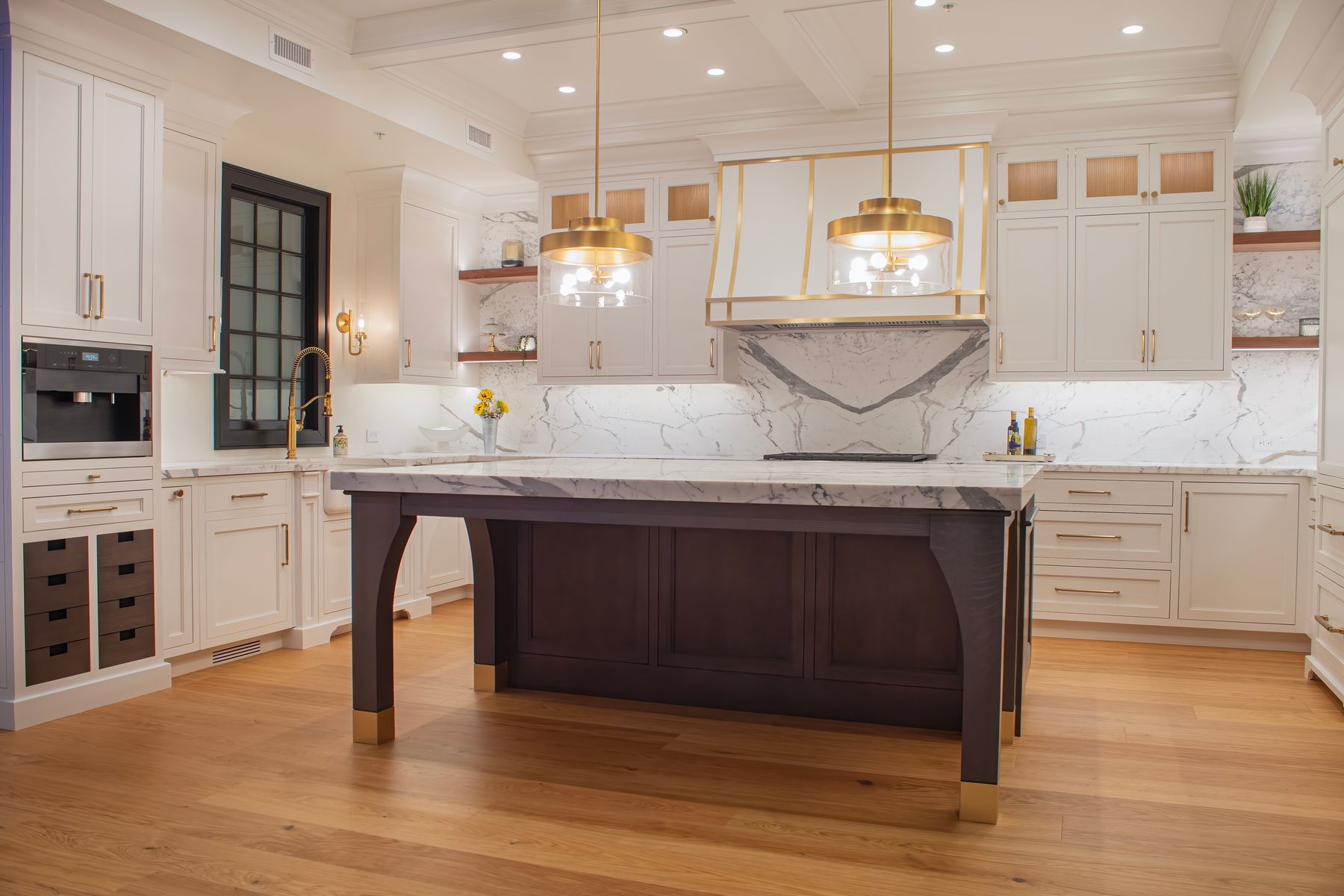 Natural oak hardwood under a marble kitchen
