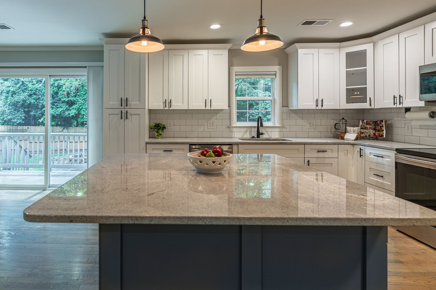 White kitchen with granite island in Fort Walton Beach, FL