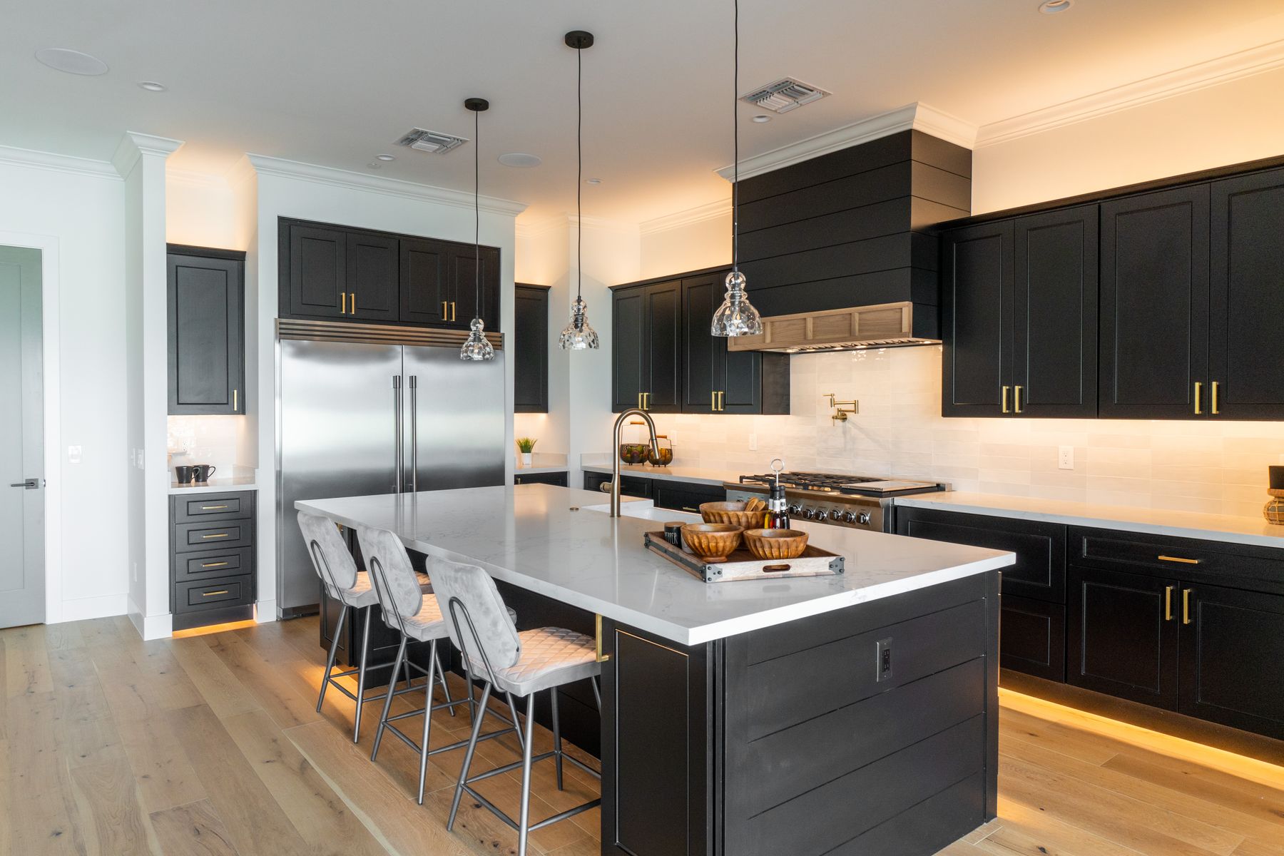 Black kitchen cabinets with white quartz island in Fort Walton Beach, FL