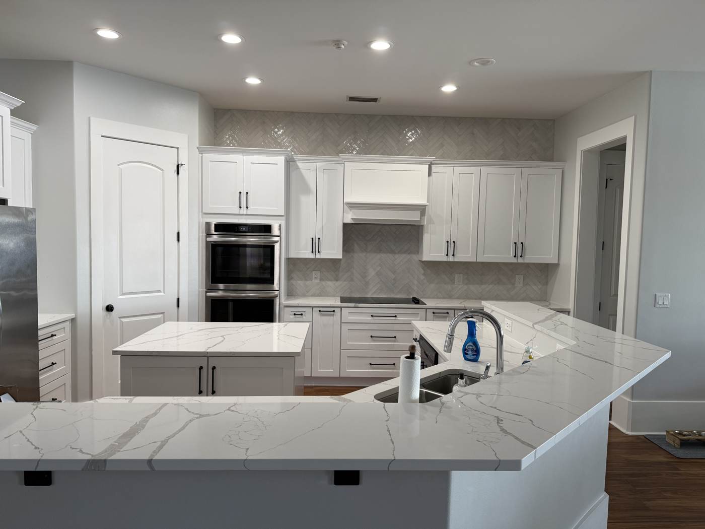 White kitchen with herringbone tile in Fort Walton Beach