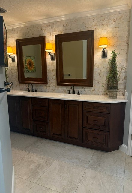 Dark KraftMaid double vanity with Cambria quartz top in Niceville