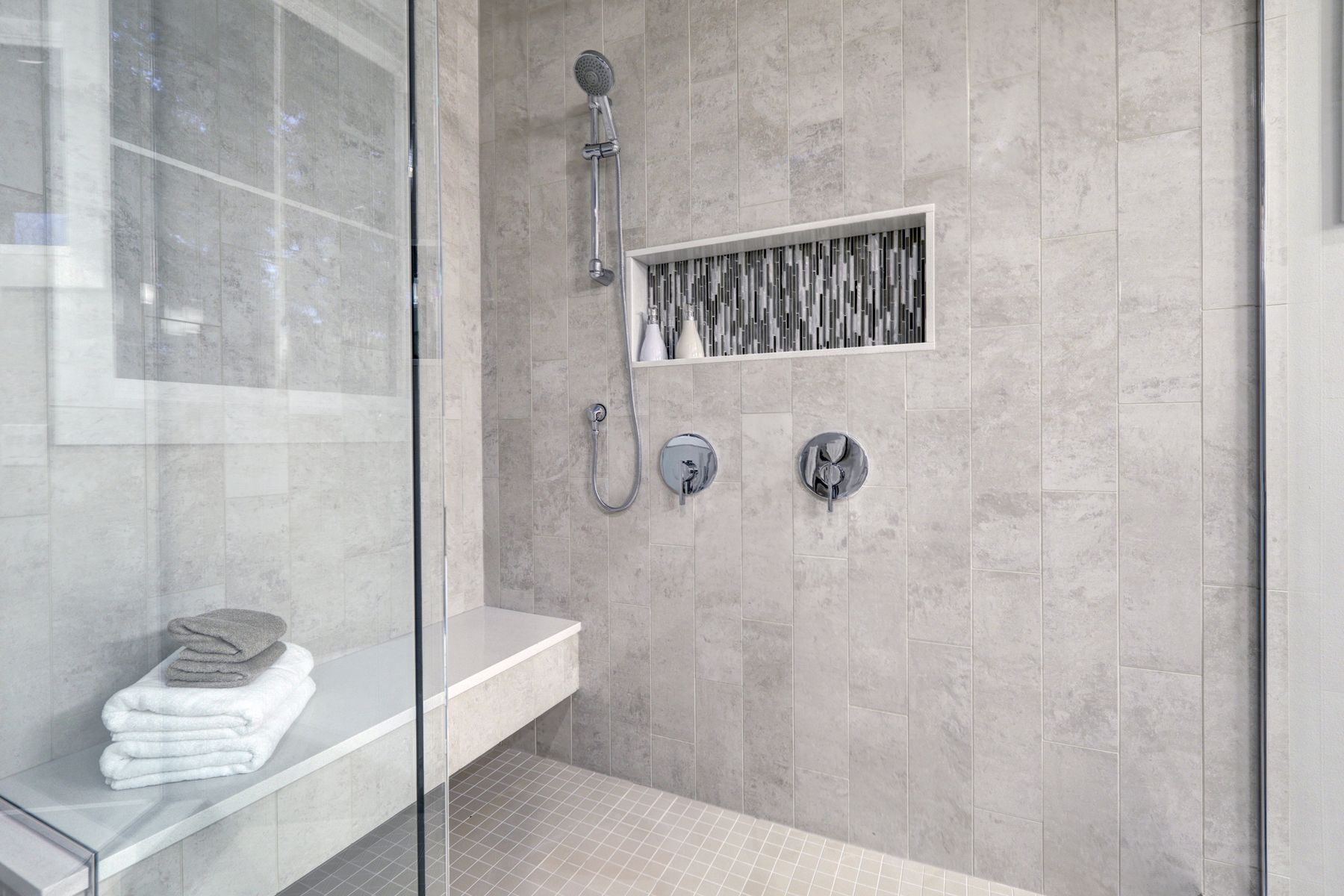 Walk-in shower with niche and bench in Fort Walton Beach