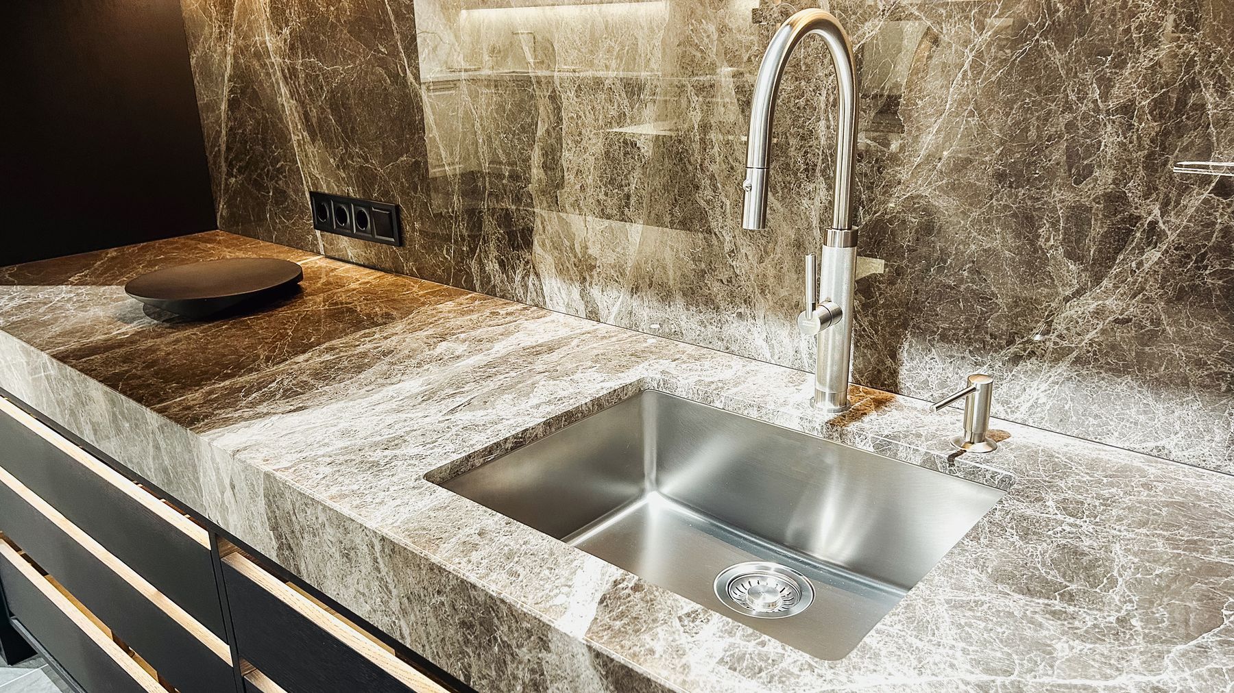 Polished stone sink deck and backsplash