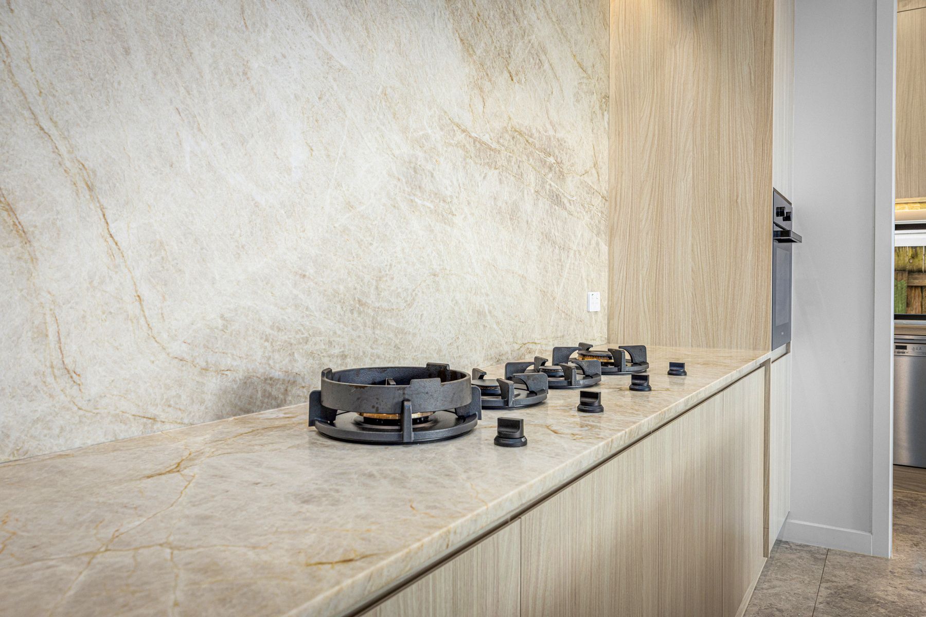 Full-height stone slab behind a cooktop