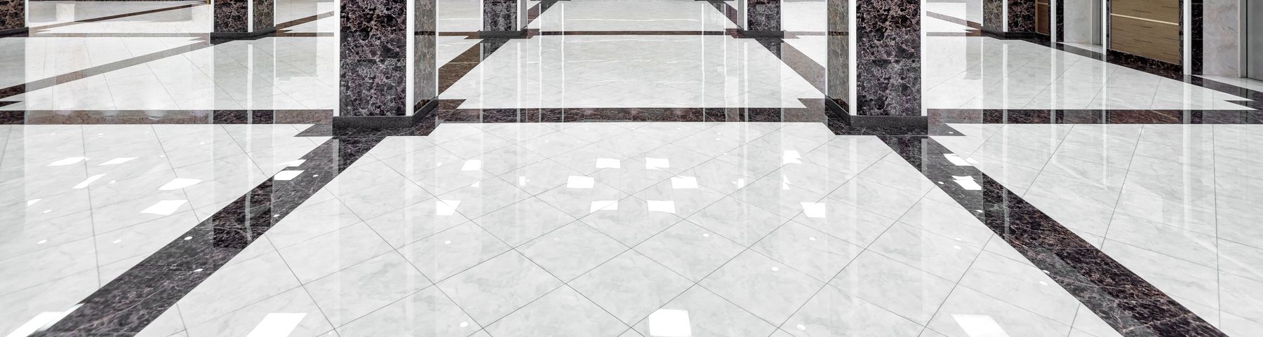 Polished stone tile floor with dark inlay