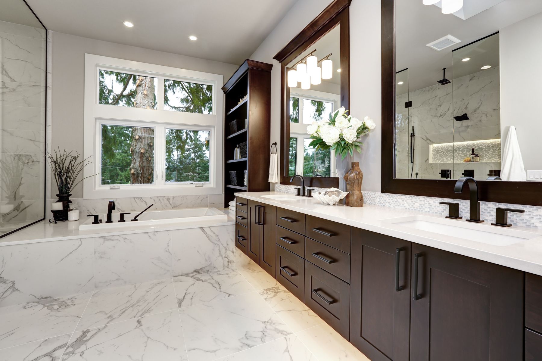 Marble deck tub surround and dark vanity