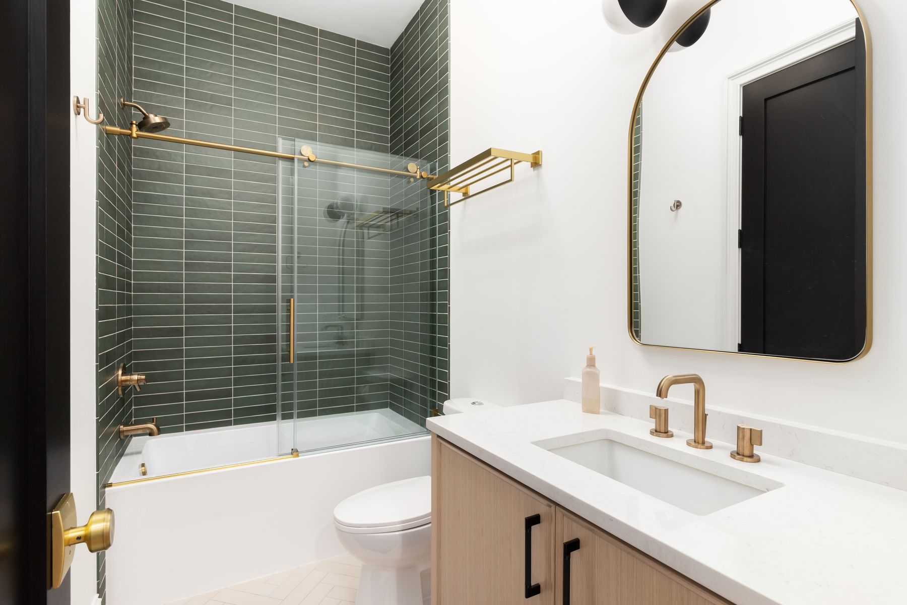 Green tile tub surround with glass door